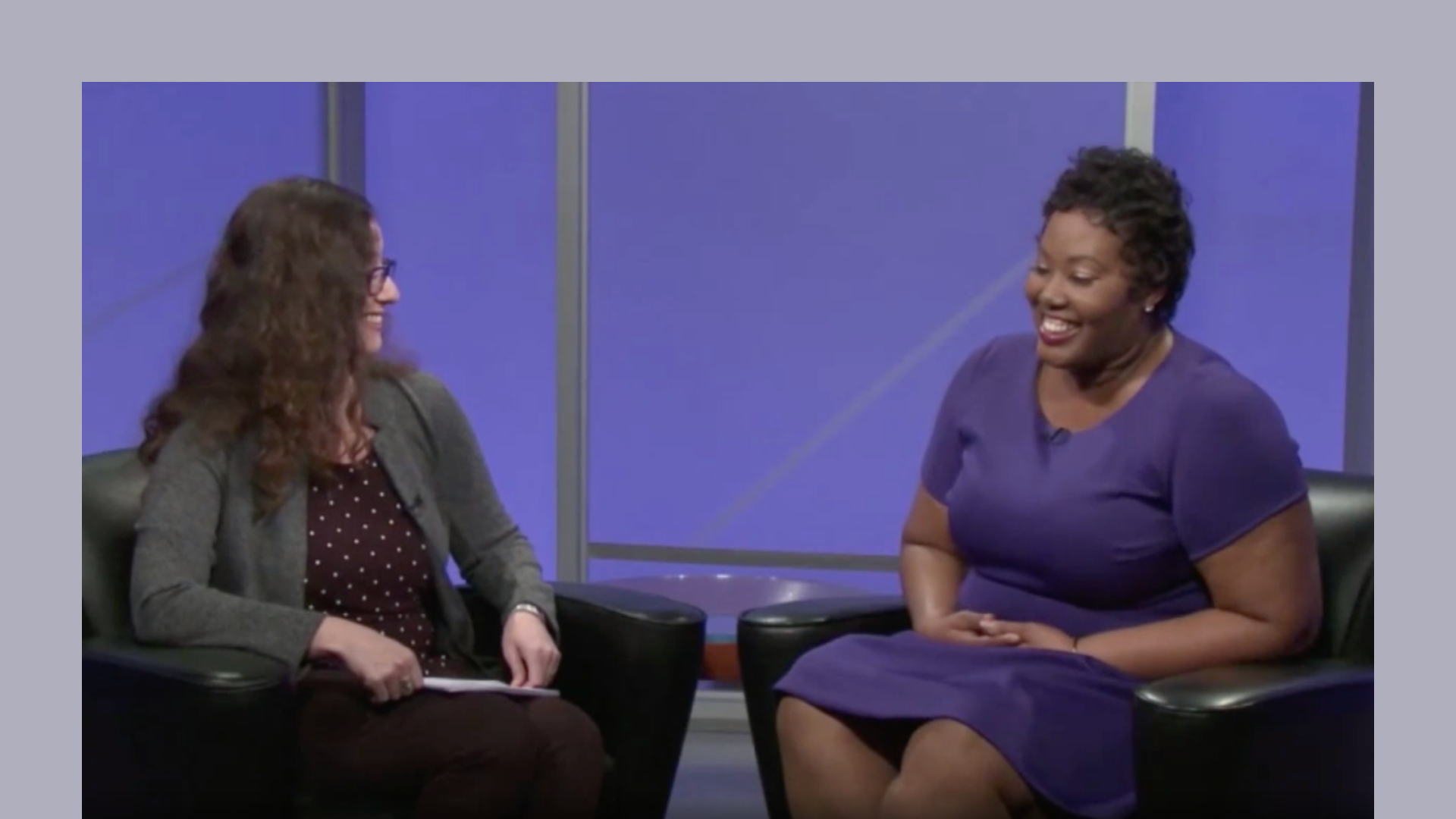 Two people sitting in chairs talking on a livestream Two people sitting in chairs talking on a livestream